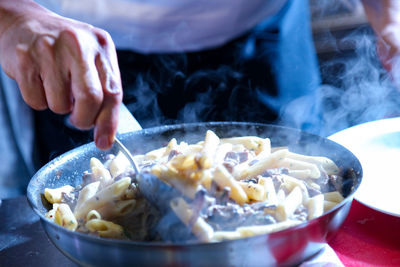 Close-up of person preparing food in kitchen