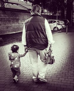 Rear view of couple walking on street