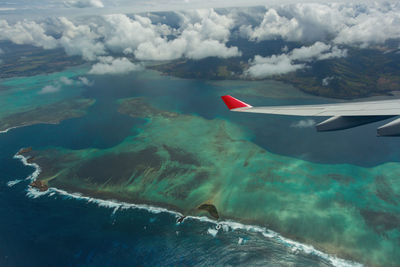 Aerial view of seascape against cloudy sky