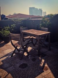 Empty chairs and tables against sky