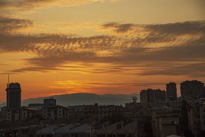 High angle view of buildings in city during sunset