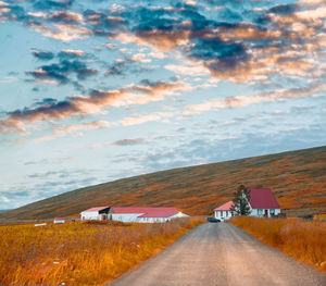 Road amidst land against sky