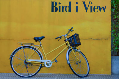 Bicycle travel idea and yellow wall