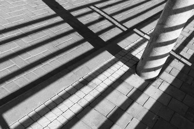 High angle view of shadow on paving stones 