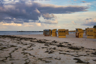 Lifeguard hut on beach against sky