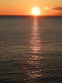 Scenic view of sea against orange sky