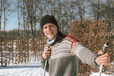 Portrait of smiling man in snow