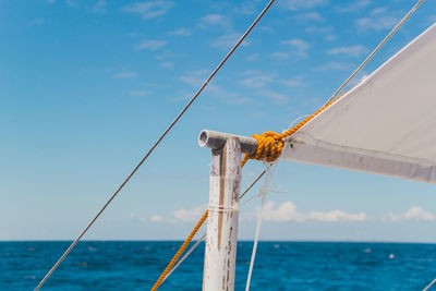 Sailboat on sea against blue sky