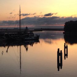 Boats in lake at sunset