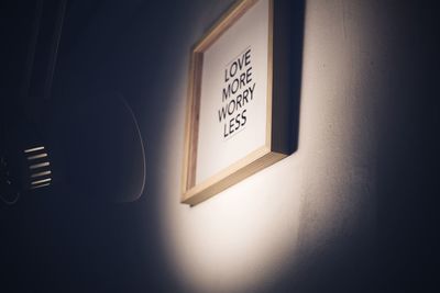 Illuminated electric lamp on wall at home