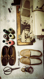 High angle view of shoes by sewing machine on table