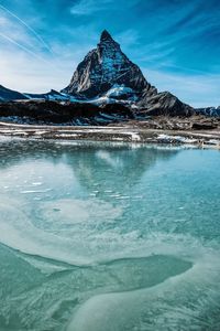 Scenic view of lake against sky during winter