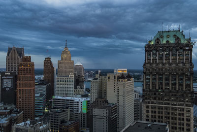 Buildings against cloudy sky at dusk