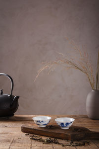 View of tea cup on table against wall