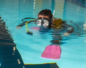 Portrait of young woman swimming in pool