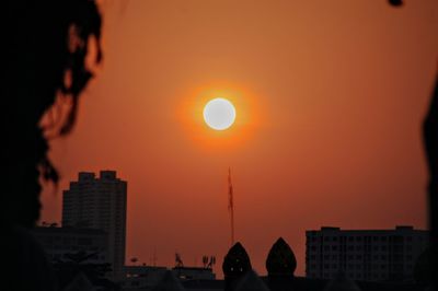 Silhouette buildings against sky during sunset