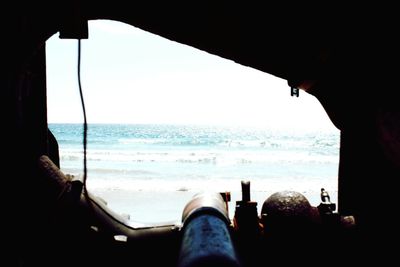 Low section of people relaxing on beach