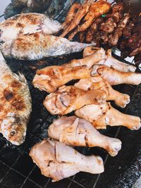 High angle view of meat on barbecue grill