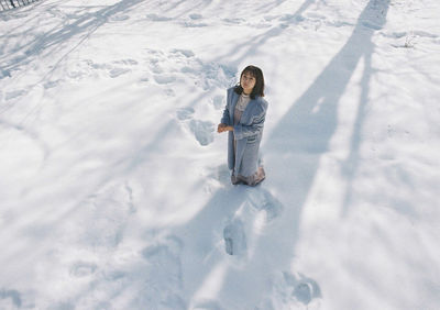 Full length of child standing on snow covered land