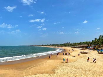 People on beach against sky