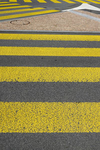 High angle view of yellow crossing sign on road