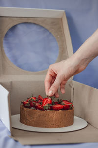 Cropped hand of person preparing food