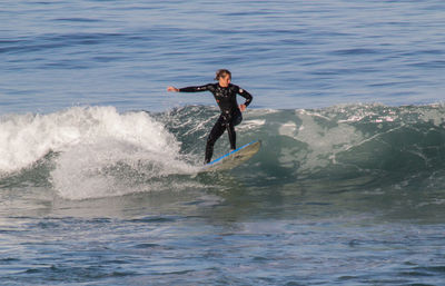 Woman jumping in sea