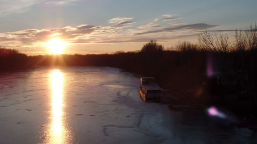 Scenic view of lake against sky during sunset