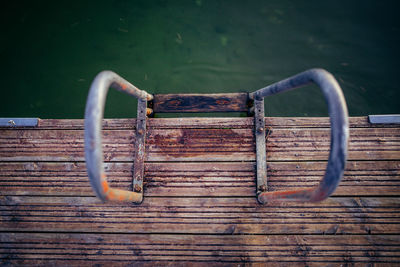 High angle view of rusty railing on pier in sea