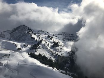 Scenic view of snow covered mountains against sky