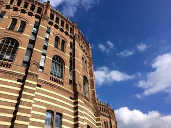 Low angle view of building against cloudy sky