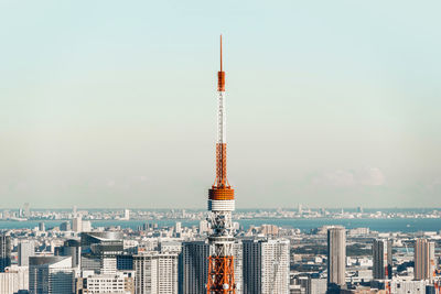 Tower amidst buildings in city against sky