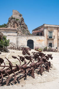 Old abandoned building against clear blue sky