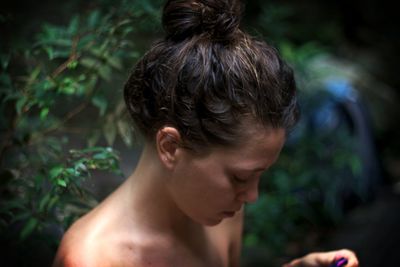 Close-up of shirtless young woman