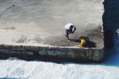 High angle view of man working in water