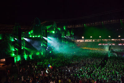 Crowd at illuminated music concert at night