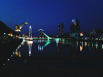 Suspension bridge over river at night