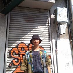 Portrait of smiling man standing against wall