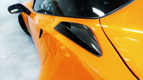 High angle view of yellow car on side-view mirror