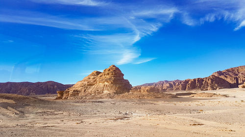 Rock formations in desert against blue sky