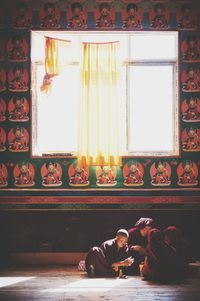 People sitting in illuminated room