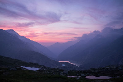 Scenic view of mountains against sky at sunset