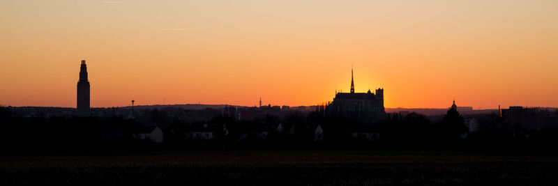 Silhouette of buildings against sky during sunset