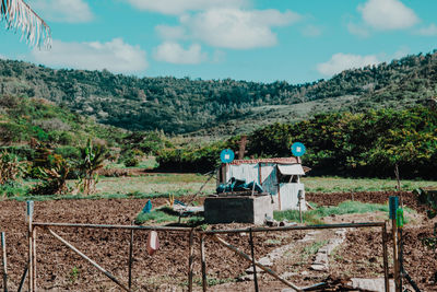 Traditional guardian house on field against sky