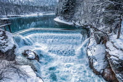 Scenic view of river flowing during winter