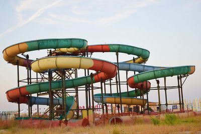 Low angle view of amusement park ride against sky