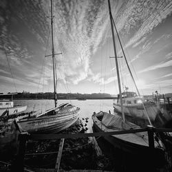 Black and white view of moored yachts with with dramatic sky
