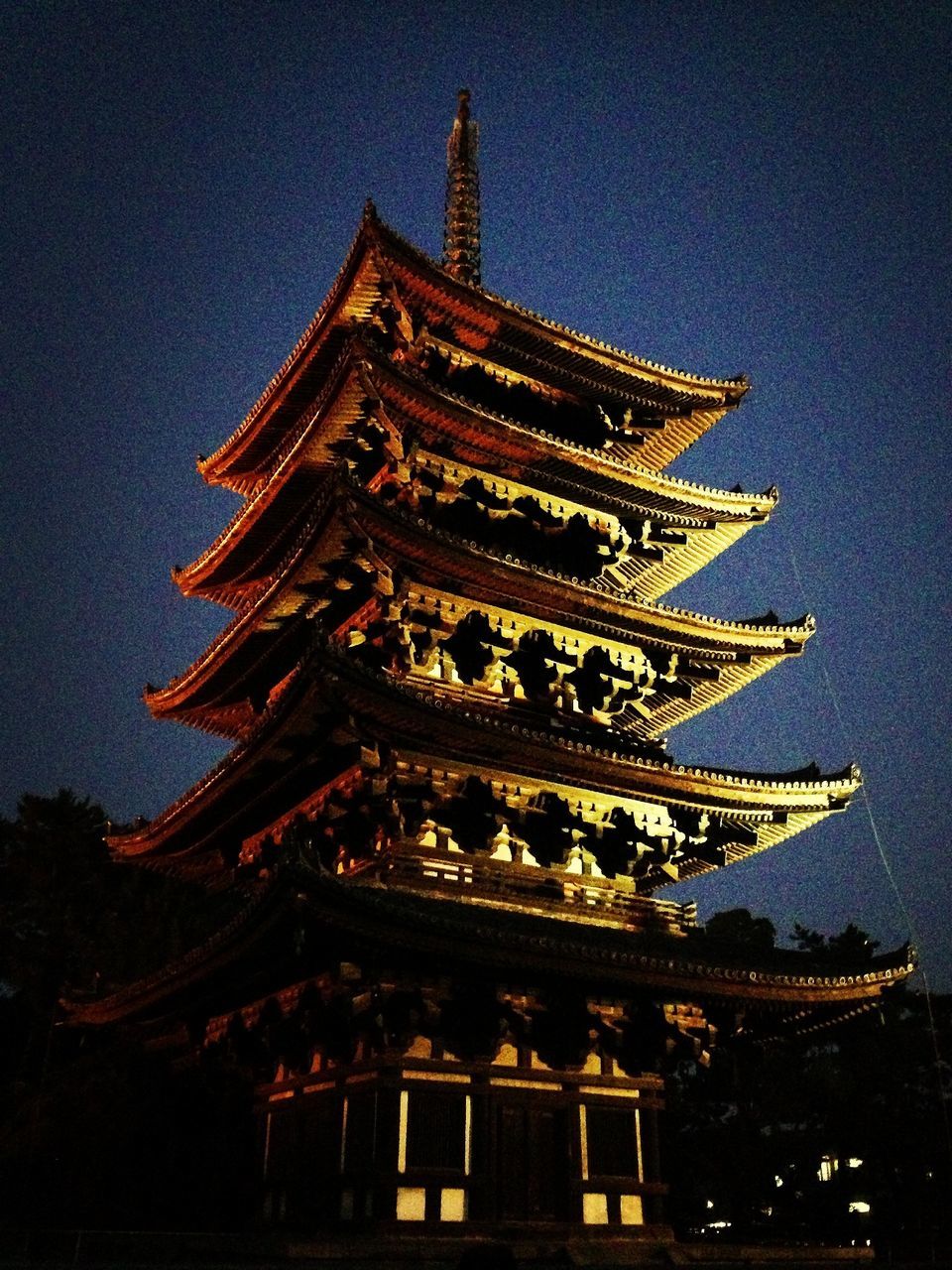 low angle view, architecture, building exterior, built structure, place of worship, illuminated, religion, night, spirituality, clear sky, temple - building, sky, famous place, travel destinations, outdoors, cultures, history, no people, tradition