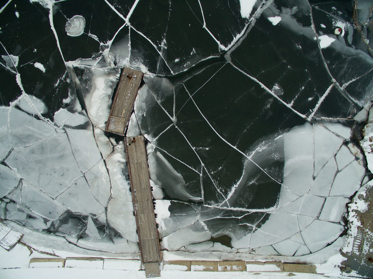 Directly above shot of cracked frozen lake