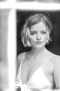 Portrait of beautiful woman standing against wall